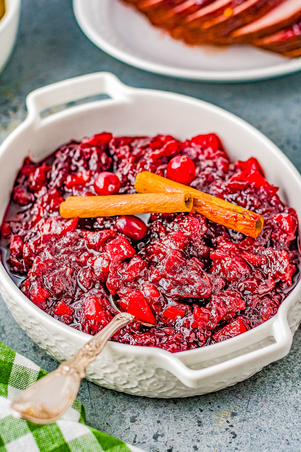 Cinnamon Apple Cranberry Sauce - Spice up your holiday celebrations with this scrumptious FAST and EASY homemade cranberry sauce that's made with cranberries, apples, apple cider, cinnamon sticks, and allspice for the PERFECT must-make side dish! A lovely balance of sweet-yet-tart with warmly spiced flavors so you'll never want to think about using store bought sauce again! 