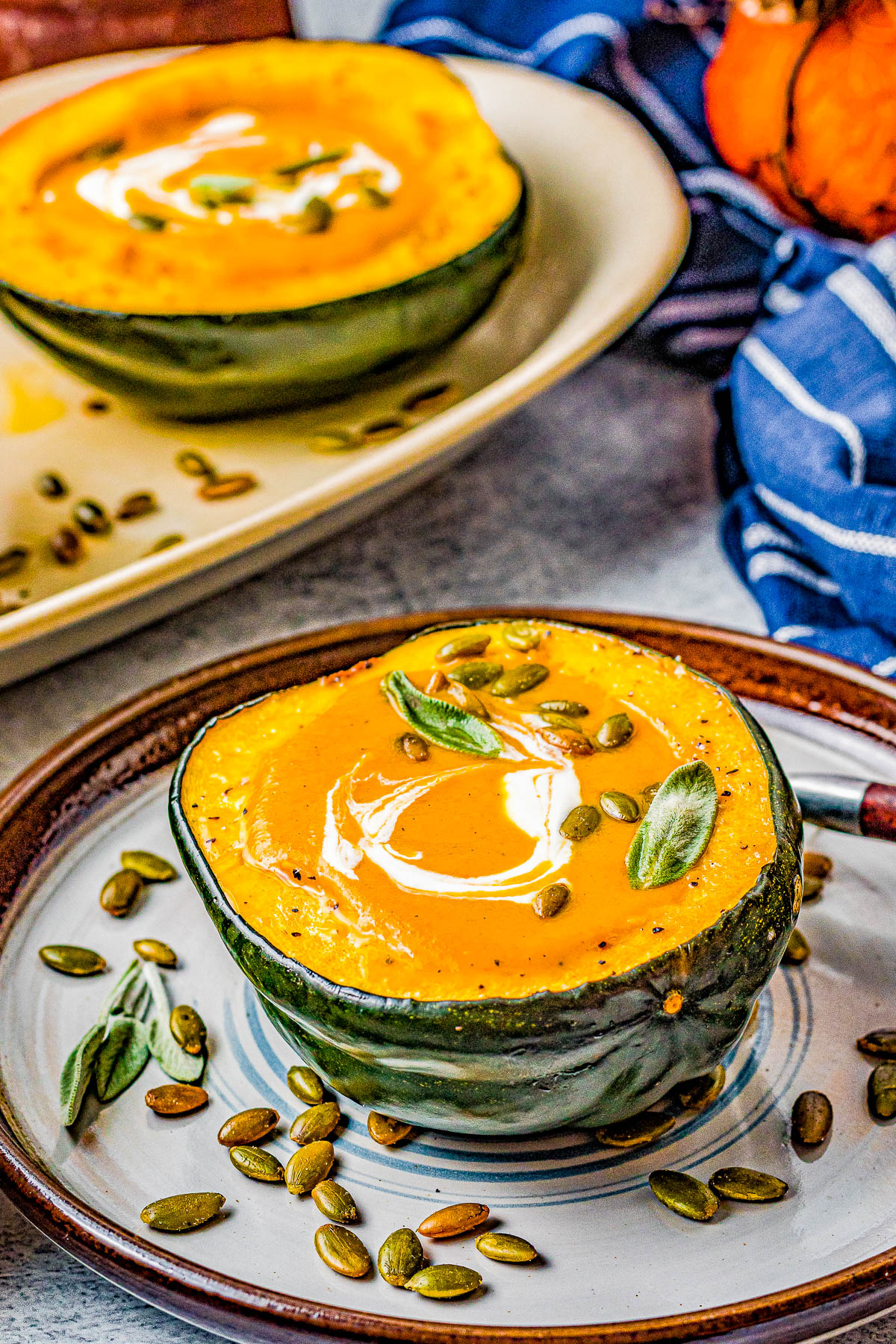Butternut Squash Soup - Made with roasted butternut and acorn squash, sweet potatoes, carrots, sage, thyme, and more to create a gorgeous, creamy, fall-inspired soup that everyone LOVES! Great as a healthy main dish or a perfect side dish for Thanksgiving or the holidays! Serve it in acorn squash bowls for an even more festive look! 