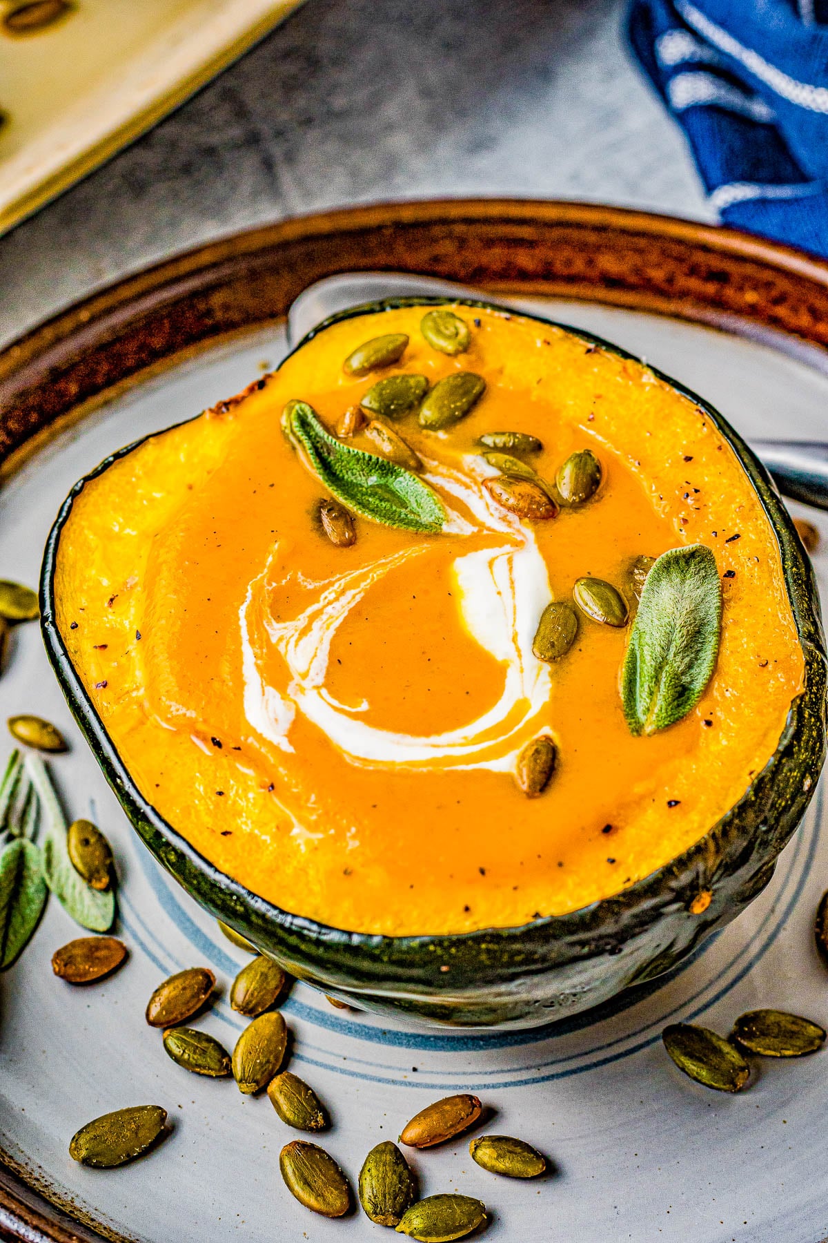 Butternut Squash Soup - Made with roasted butternut and acorn squash, sweet potatoes, carrots, sage, thyme, and more to create a gorgeous, creamy, fall-inspired soup that everyone LOVES! Great as a healthy main dish or a perfect side dish for Thanksgiving or the holidays! Serve it in acorn squash bowls for an even more festive look! 