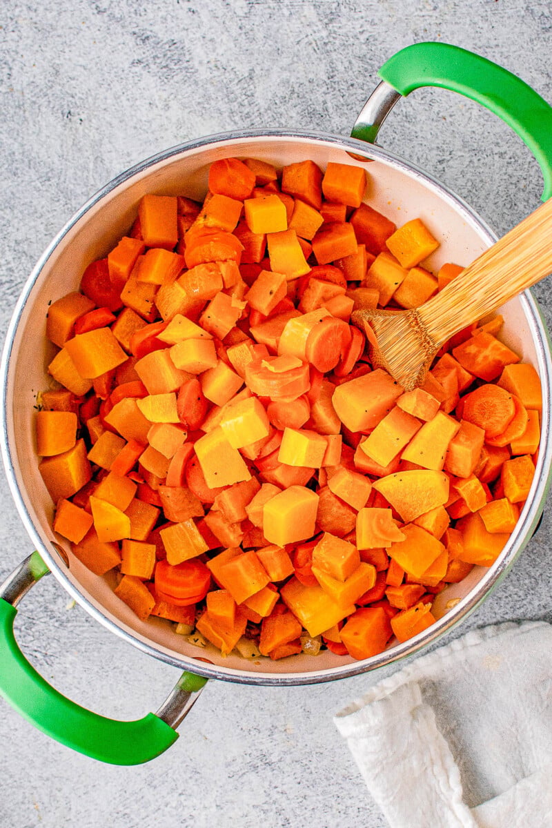 Butternut Squash Soup - Made with roasted butternut and acorn squash, sweet potatoes, carrots, sage, thyme, and more to create a gorgeous, creamy, fall-inspired soup that everyone LOVES! Great as a healthy main dish or a perfect side dish for Thanksgiving or the holidays! Serve it in acorn squash bowls for an even more festive look! 