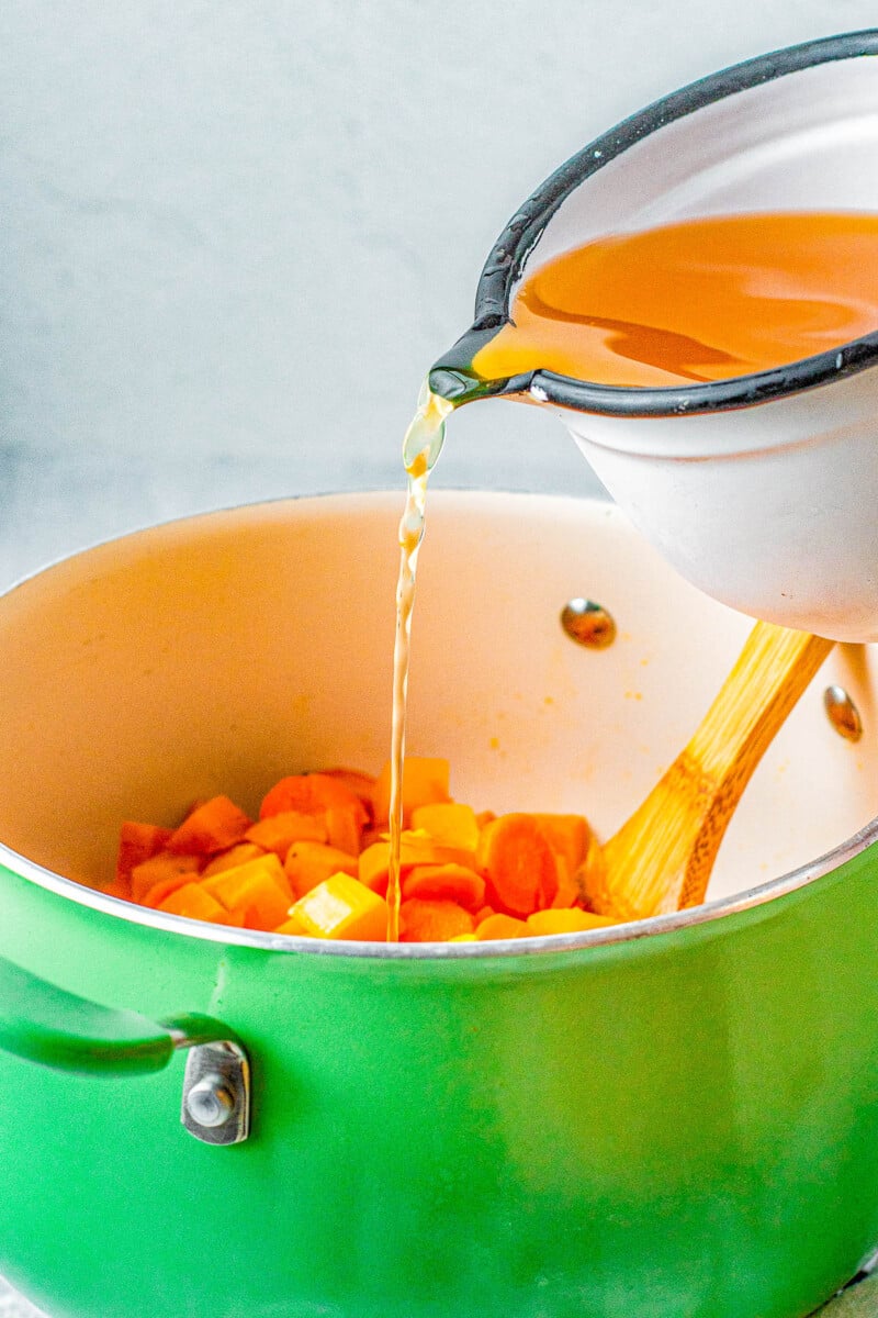Butternut Squash Soup - Made with roasted butternut and acorn squash, sweet potatoes, carrots, sage, thyme, and more to create a gorgeous, creamy, fall-inspired soup that everyone LOVES! Great as a healthy main dish or a perfect side dish for Thanksgiving or the holidays! Serve it in acorn squash bowls for an even more festive look! 