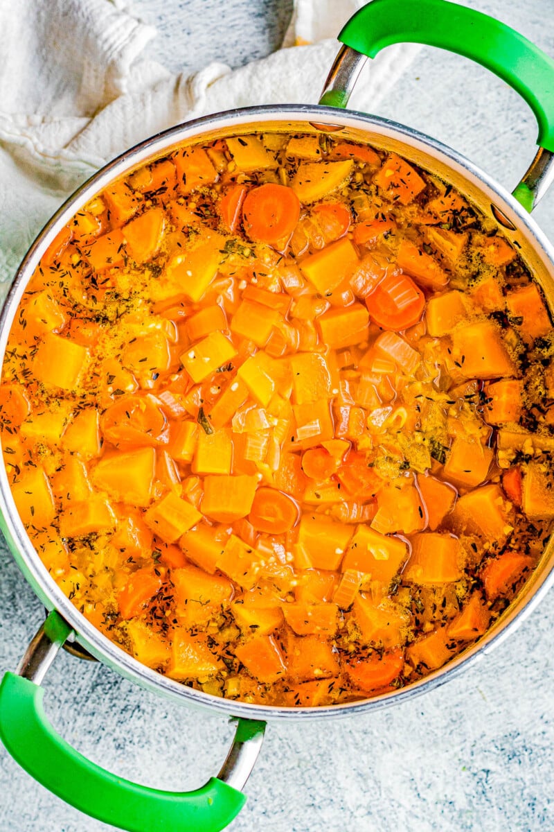 Butternut Squash Soup - Made with roasted butternut and acorn squash, sweet potatoes, carrots, sage, thyme, and more to create a gorgeous, creamy, fall-inspired soup that everyone LOVES! Great as a healthy main dish or a perfect side dish for Thanksgiving or the holidays! Serve it in acorn squash bowls for an even more festive look! 