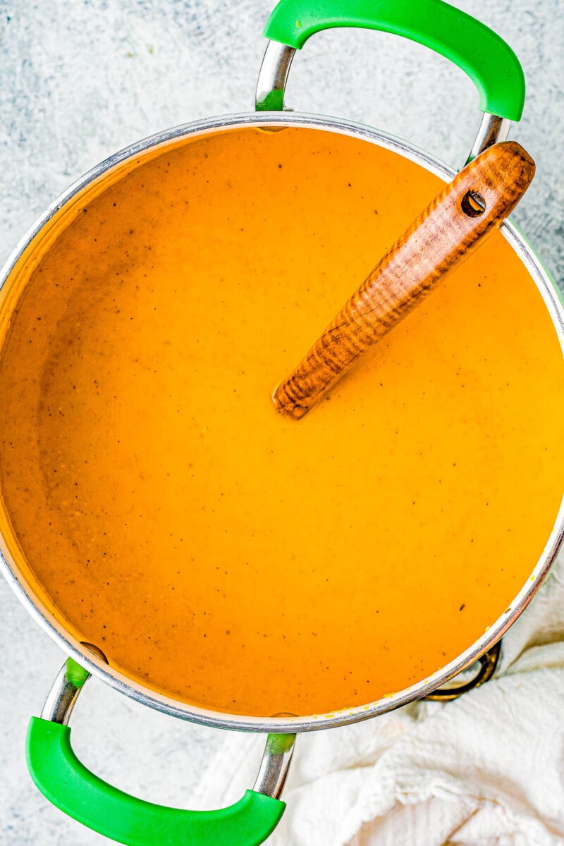 Butternut Squash Soup - Made with roasted butternut and acorn squash, sweet potatoes, carrots, sage, thyme, and more to create a gorgeous, creamy, fall-inspired soup that everyone LOVES! Great as a healthy main dish or a perfect side dish for Thanksgiving or the holidays! Serve it in acorn squash bowls for an even more festive look! 