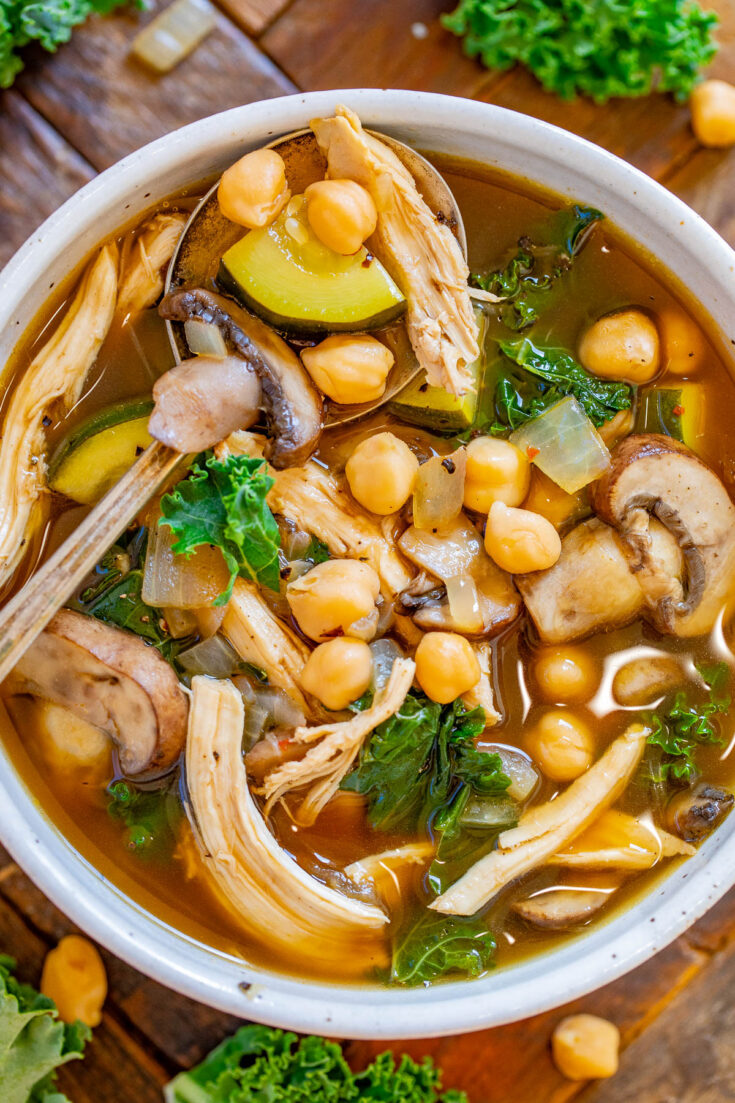 Chicken Vegetable Soup with Garbanzo Beans - Healthy yet hearty and ready in 30 minutes, this EASY chicken soup is perfect for chilly weather! Complete with juicy shredded chicken, mushrooms, tender garbanzo beans, zucchini and kale for a green pop in this noodle-free family favorite! 