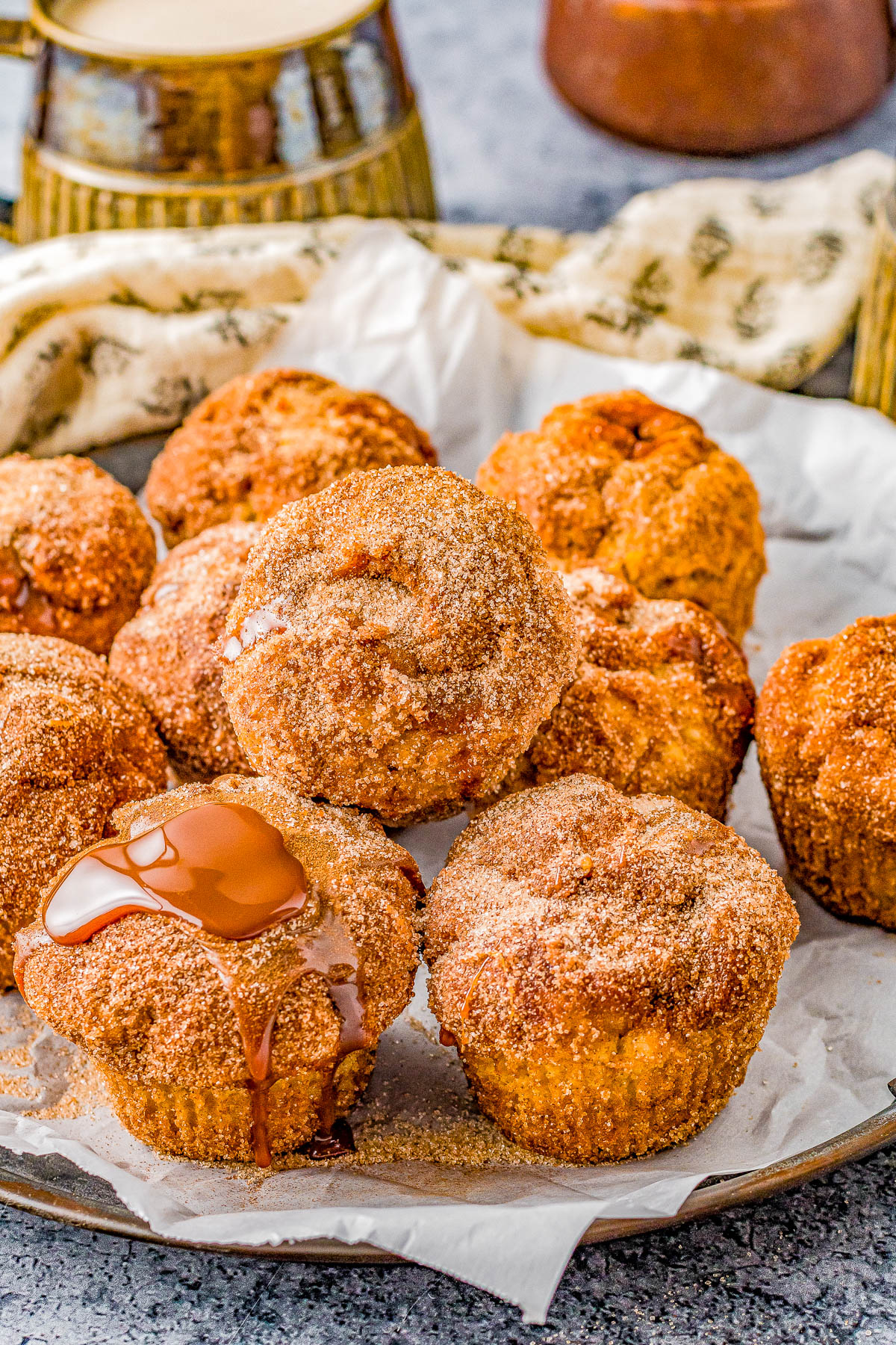 Dulce de Leche Churro Muffins - All the flavors and satisfaction of fresh churros but in muffin form with no frying involved! Brushed with melted butter, rolled in cinnamon-and-sugar, and filled with dulce de leche or caramel sauce, these FAST and EASY muffins are so soft, moist, and PERFECTLY decadent! 
