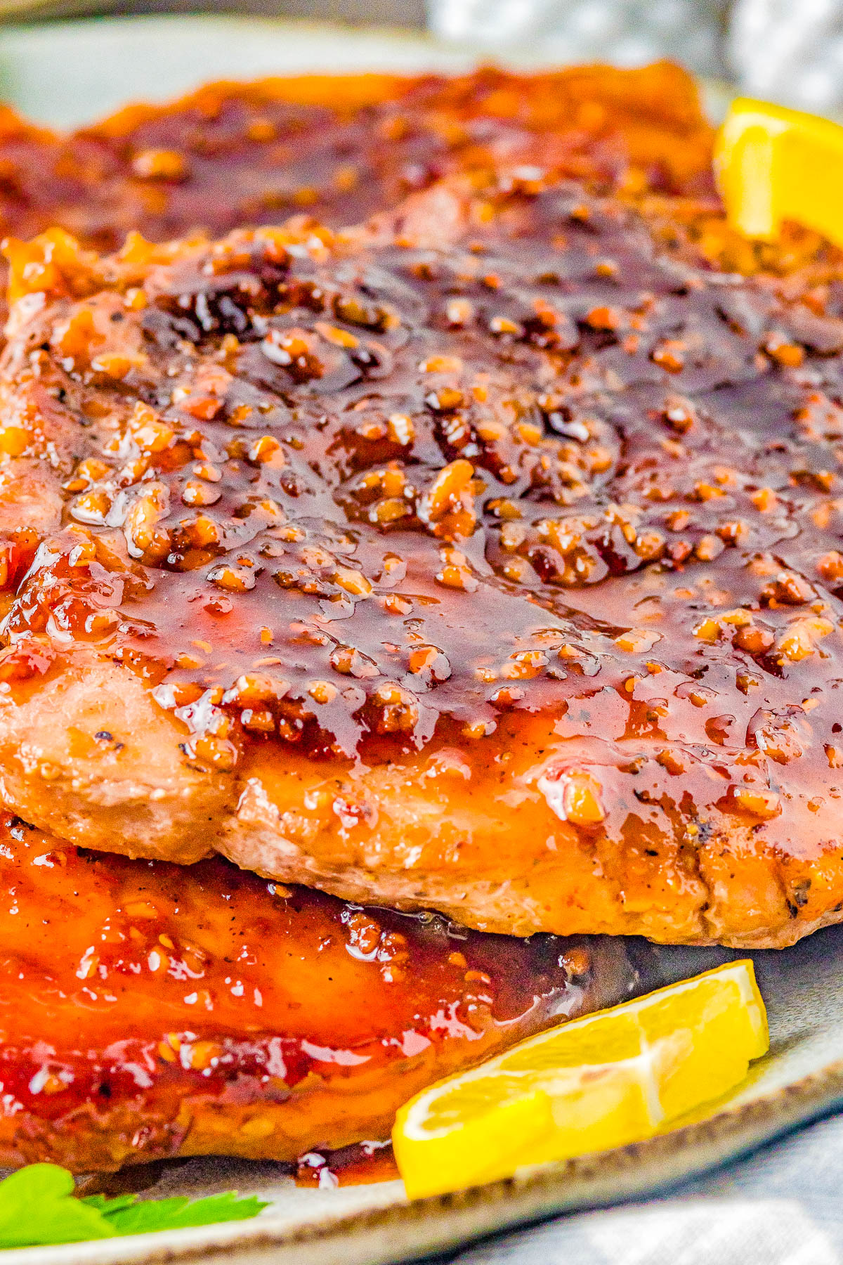 Maple Glazed Pork Chops and Sweet Potatoes - The PERFECT fall-inspired dinner with juicy pork chops that are smothered with the most mouthwatering maple bourbon glaze and cinnamon-and-spiced roasted sweet potatoes on the side! This stunning comfort food recipe is great for family dinners and busy weeknights because it's EASY to make!  