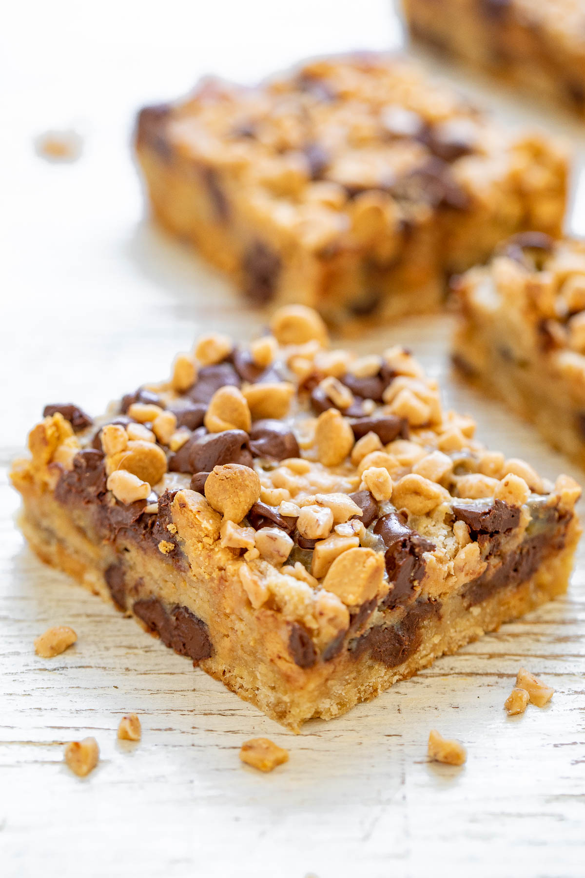 Peanut Butter Chocolate Chip Toffee Bars - Thick, rich, decadent cookie bars made with chocolate chips, peanut butter chips, creamy sweetened condensed milk, and crunchy toffee bits! A FAST and EASY no mixer, one bowl recipe that is sure to impress friends and family! The bars also keep fresh for a long time and are a great make-ahead dessert or great for gifting.