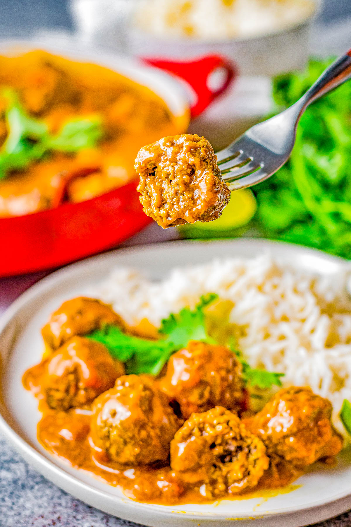 Red Curry Meatballs - Indian-spiced beef meatballs are simmered in a homemade red curry sauce that's perfectly spicy, savory, and so comforting especially when served over a bed of basmati rice! Learn how to recreate this ethnic dish that'll IMPRESS your family and friends and have everyone begging for more!