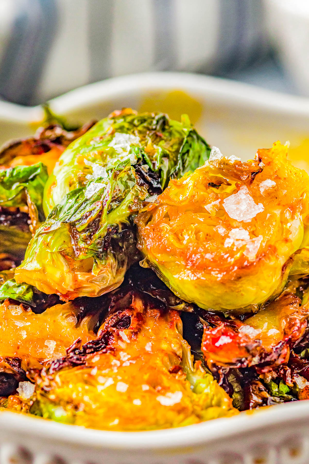 Air Fryer Brussels Sprouts with Sweet and Spicy Glaze - The air fryer makes these Brussels sprouts perfectly crispy on the outside, tender on the inside, and the mildly spicy honey butter glaze makes them IRRESISTIBLE! An EASY side dish for busy weeknights, family dinners, or Thanksgiving that's ready FAST!