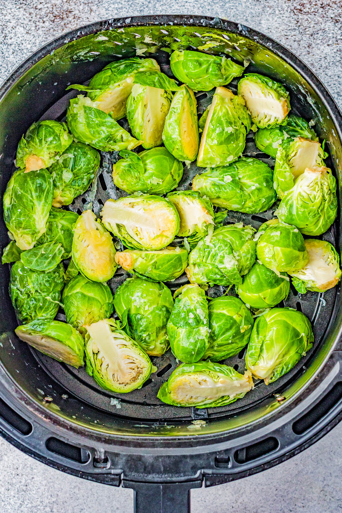 Air Fryer Brussels Sprouts with Sweet and Spicy Glaze - The air fryer makes these Brussels sprouts perfectly crispy on the outside, tender on the inside, and the mildly spicy honey butter glaze makes them IRRESISTIBLE! An EASY side dish for busy weeknights, family dinners, or Thanksgiving that's ready FAST!