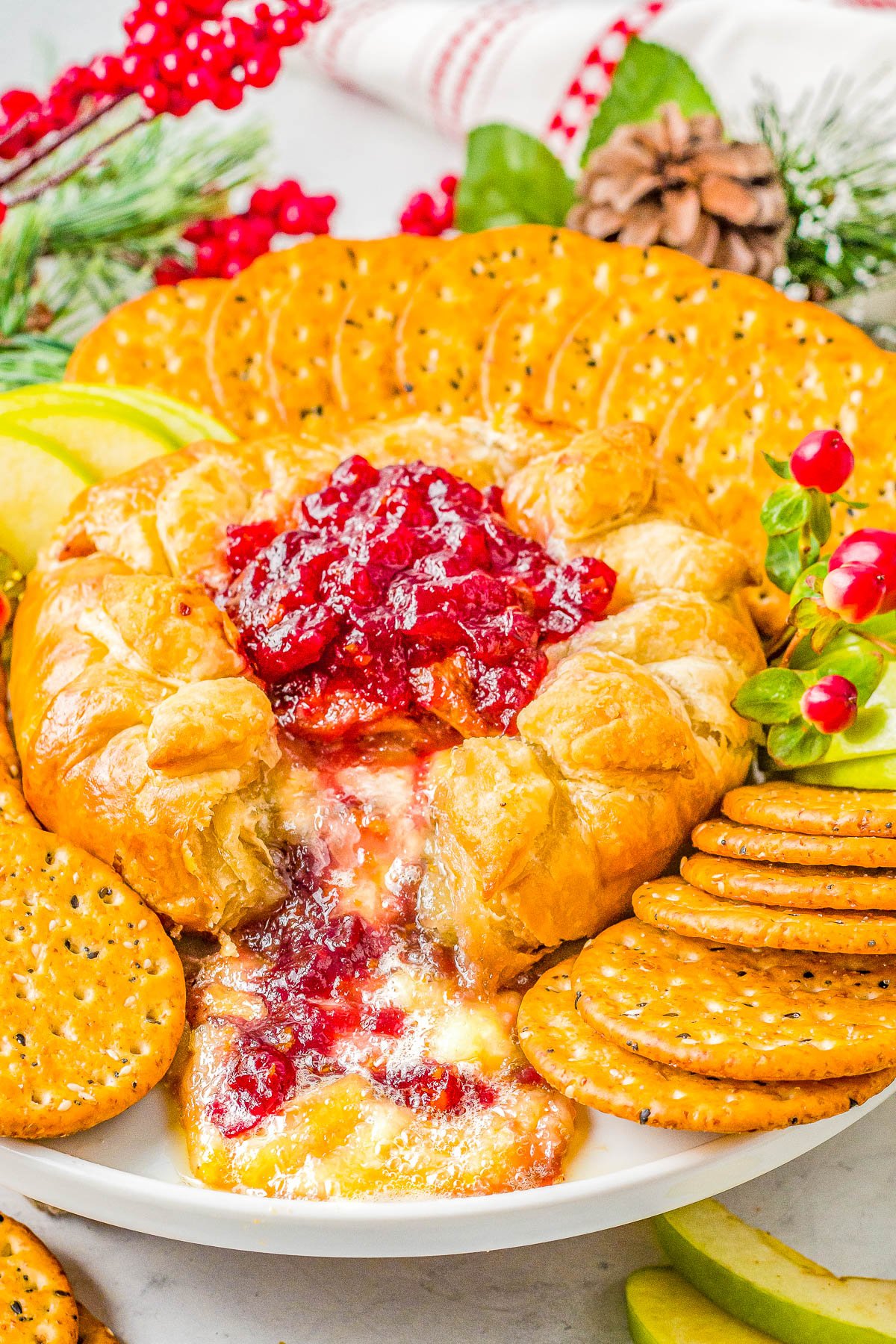 Baked Brie in Puff Pastry - Warm melted cheese, layered with cranberry sauce, and baked in flaky puff pastry is a crowd FAVORITE appetizer! Fast and EASY for you, IRRESISTIBLE for everyone else! It's the PERFECT holiday appetizer for Thanksgiving, Christmas, holiday parties, or New Year's Eve! 