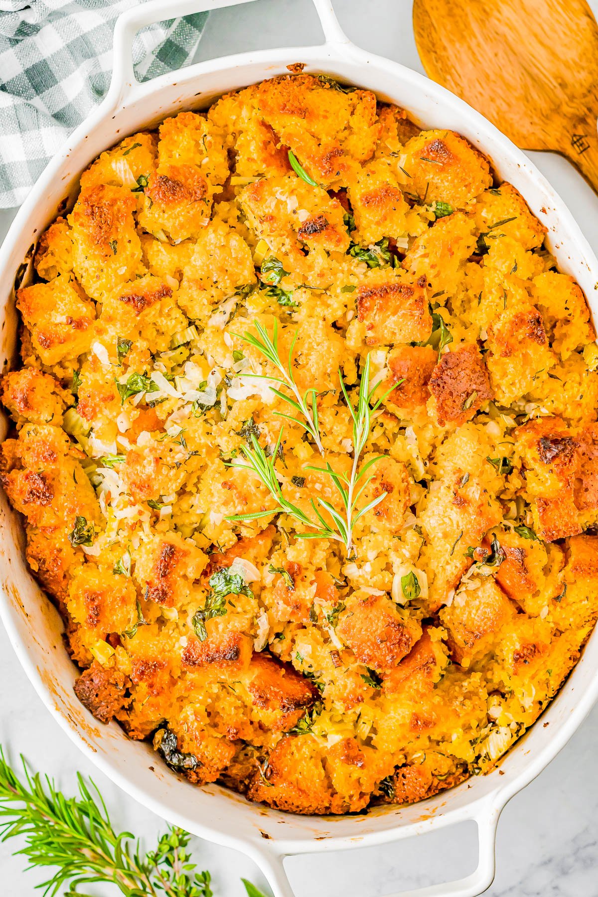 Cornbread Stuffing - Fast and easy homemade cornbread is transformed into a family favorite cornbread stuffing side dish with the addition of celery, onions, garlic, broth, and a bouquet of fresh herbs! Soft, tender, EASY, and sure to become a hit at your Thanksgiving and Christmas holiday celebrations! 