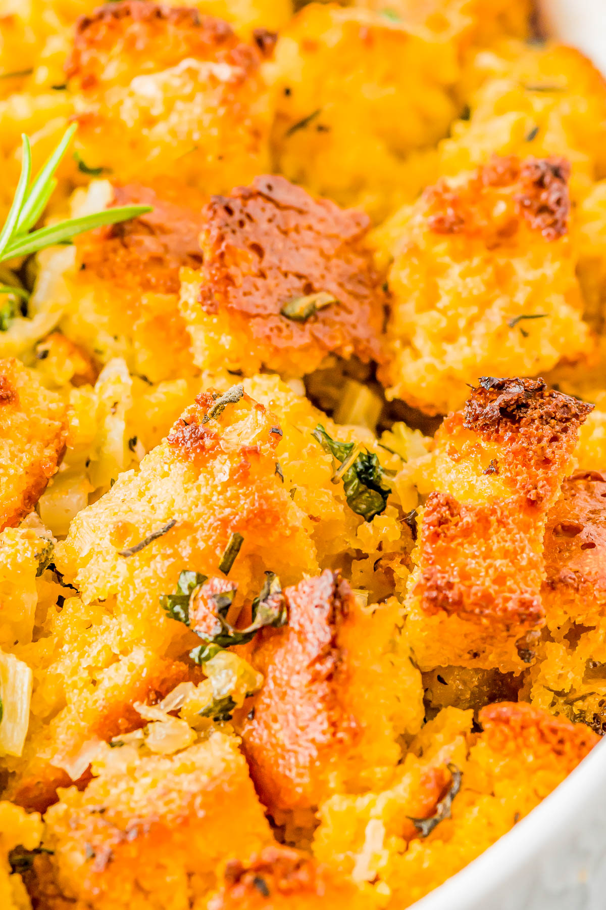 Cornbread Stuffing - Fast and easy homemade cornbread is transformed into a family favorite cornbread stuffing side dish with the addition of celery, onions, garlic, broth, and a bouquet of fresh herbs! Soft, tender, EASY, and sure to become a hit at your Thanksgiving and Christmas holiday celebrations! 