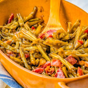 Green Beans with Bacon - Think it's impossible to love green beans? Guess again! These green beans are made extra delish with brown sugar, onions, garlic, and plenty of bacon! Eating your veggies has never been this EASY or tasty and even the pickiest eaters will gobble them up! Perfect for busy weeknights or as a great holiday side dish for Thanksgiving or Christmas!