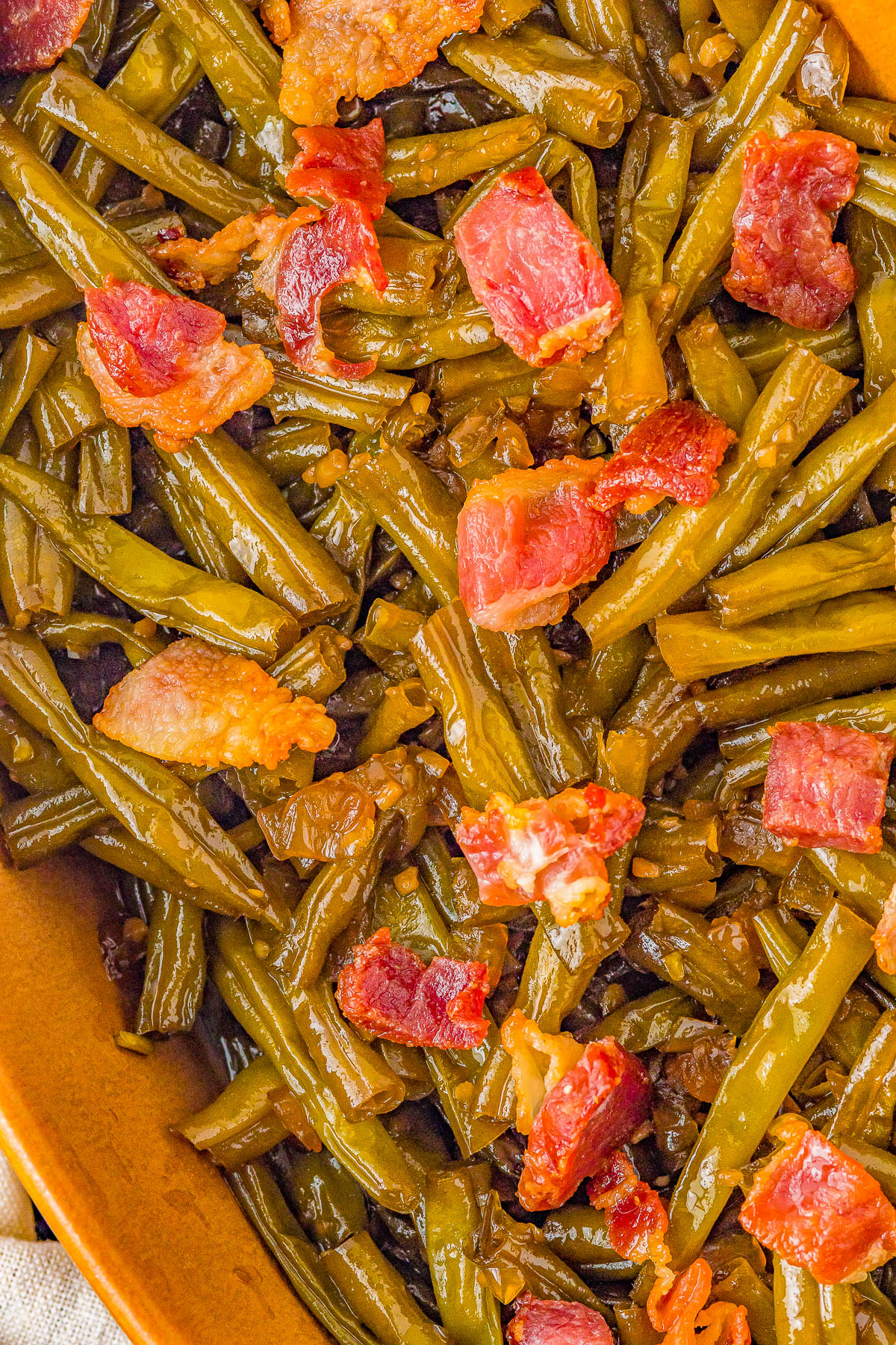 Green Beans with Bacon - Think it's impossible to love green beans? Guess again! These green beans are made extra delish with brown sugar, onions, garlic, and plenty of bacon! Eating your veggies has never been this EASY or tasty and even the pickiest eaters will gobble them up! Perfect for busy weeknights or as a great holiday side dish for Thanksgiving or Christmas!