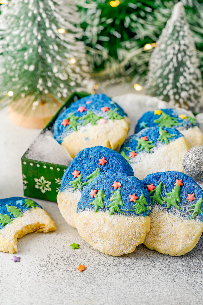 Glazed Christmas Shortbread Cookies - Jazz up typical Christmas shortbread cookies with these two-toned, soft and buttery shortbread cookies! They have fun and festive star-shaped sprinkles and are decorated with white chocolate Christmas trees making them perfect for holiday entertaining and cookie exchanges. They look impressive, but are easy enough for beginning bakers! 