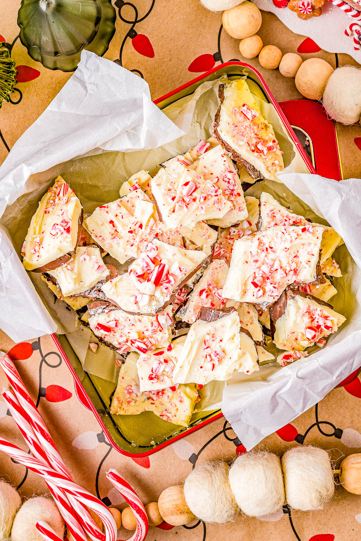 Peppermint Bark - An EASY, no-bake, and make-ahead recipe for homemade peppermint bark! This classic Christmas candy never goes out of style and is perfect for gifting, holiday parties, or cookie exchanges! No one can resist a piece of this festive looking and oh-so-pepperminty treat made with both semi-sweet and white chocolate, and crushed peppermints! 