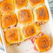 Turkey and Cheese Sliders - Juicy turkey, Swiss cheese, and cranberry sauce all nestled in soft Hawaiian rolls that are brushed with butter and topped with poppy seeds for the BEST turkey sliders! FAST, EASY, and takes advantage of leftover turkey! Deli turkey also works.