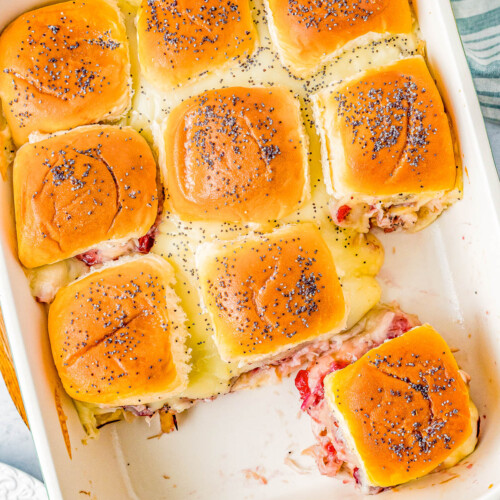 Turkey and Cheese Sliders - Juicy turkey, Swiss cheese, and cranberry sauce all nestled in soft Hawaiian rolls that are brushed with butter and topped with poppy seeds for the BEST turkey sliders! FAST, EASY, and takes advantage of leftover turkey! Deli turkey also works.