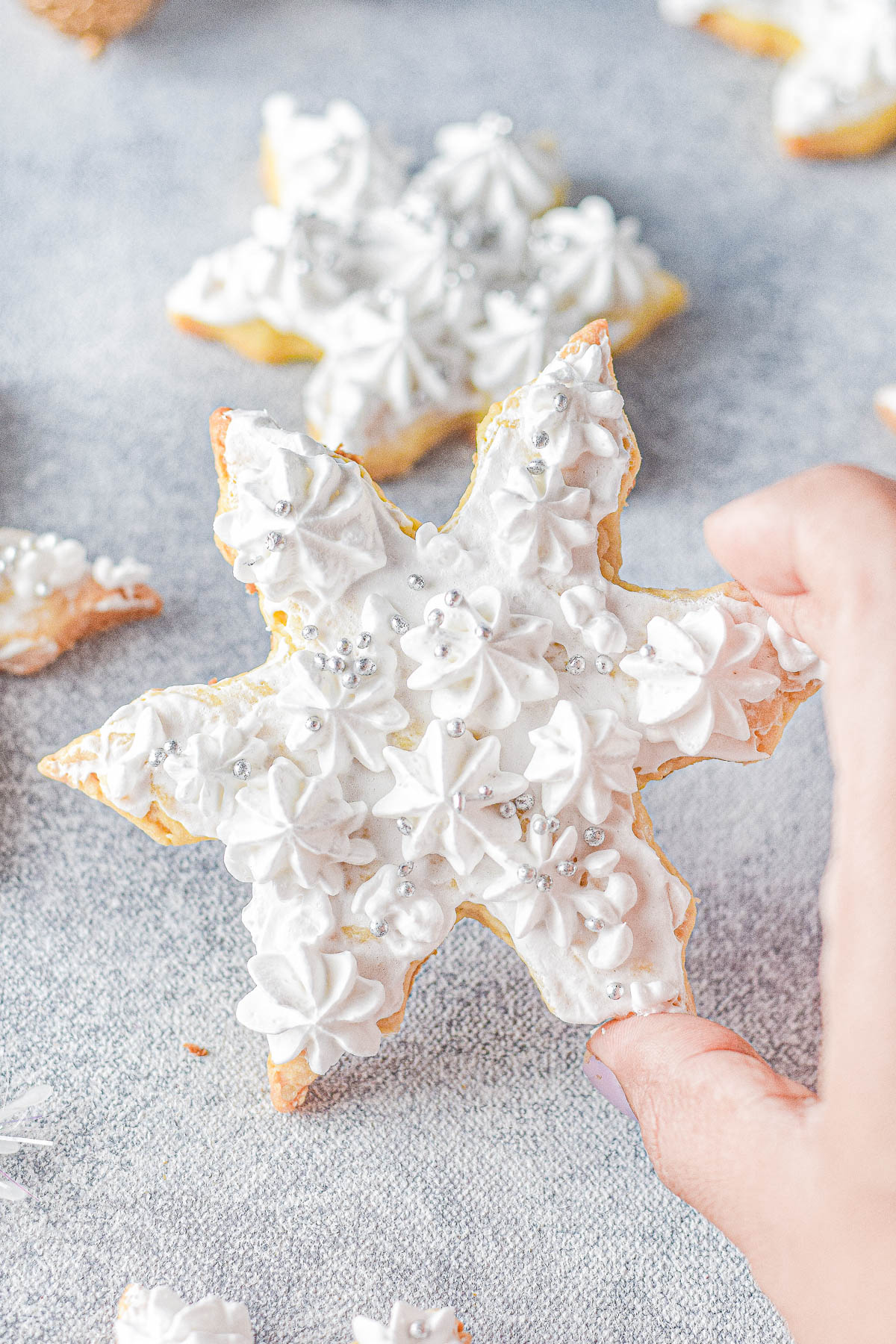 Frosted Snowflake Sugar Cookies - Classic sugar cookies that are heavenly sweet, soft, and all dressed up with piped vanilla frosting and sprinkles! They're always the biggest hit at Christmas parties and cookie exchanges! Easy enough for novice bakers thanks to my straightforward directions which set you up for PERFECT Christmas cookies!