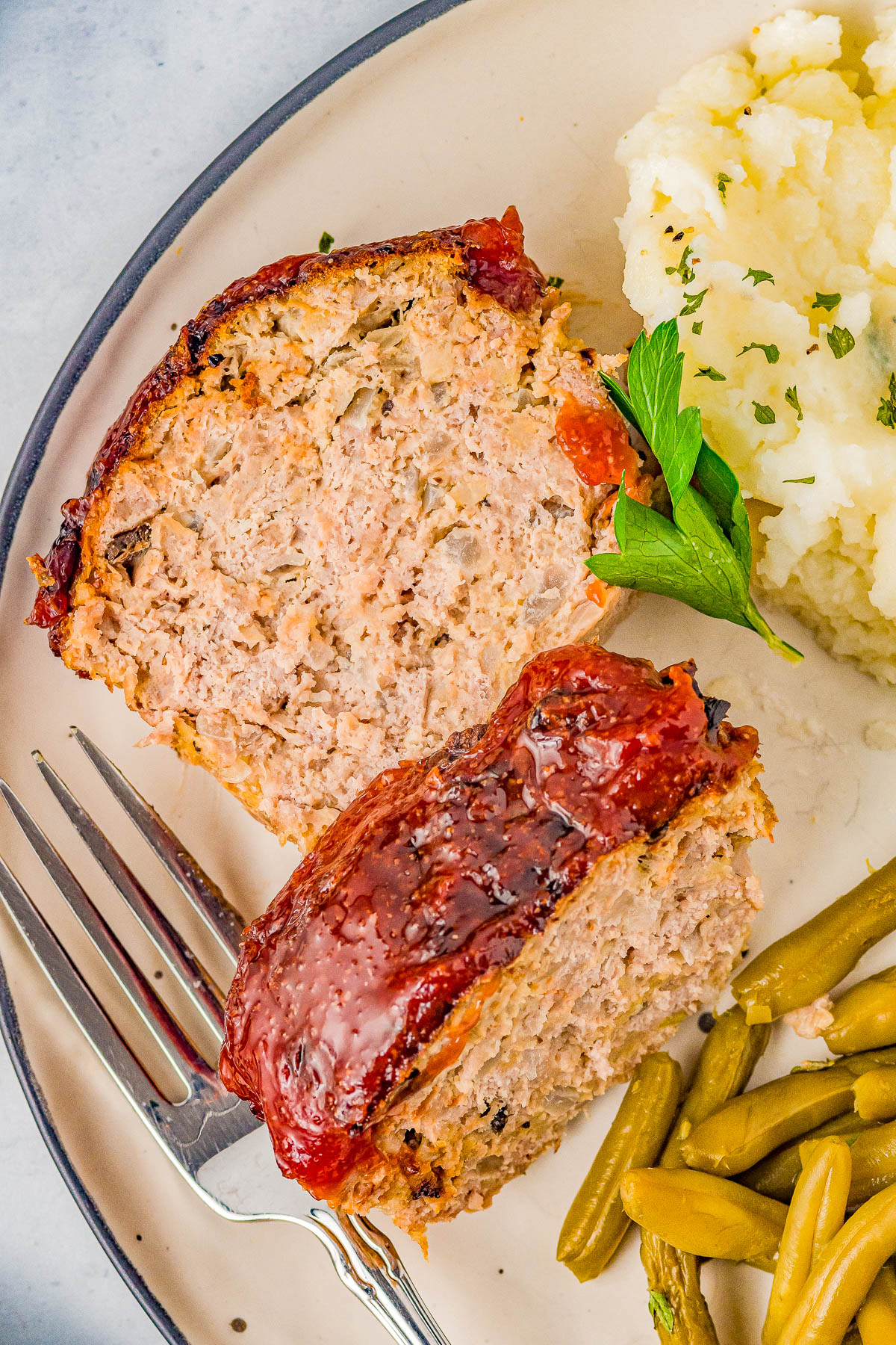 Air Fryer Meatloaf - Learn how to make AMAZING meatloaf in your air fryer! It cooks in half the time that it does in the oven, has perfectly crisped edges, and the interior stays juicy and moist! I use ground turkey or ground chicken to keep it HEALTHIER but ground pork, ground sausage, or ground beef can be used! Oven baking instructions also provided.