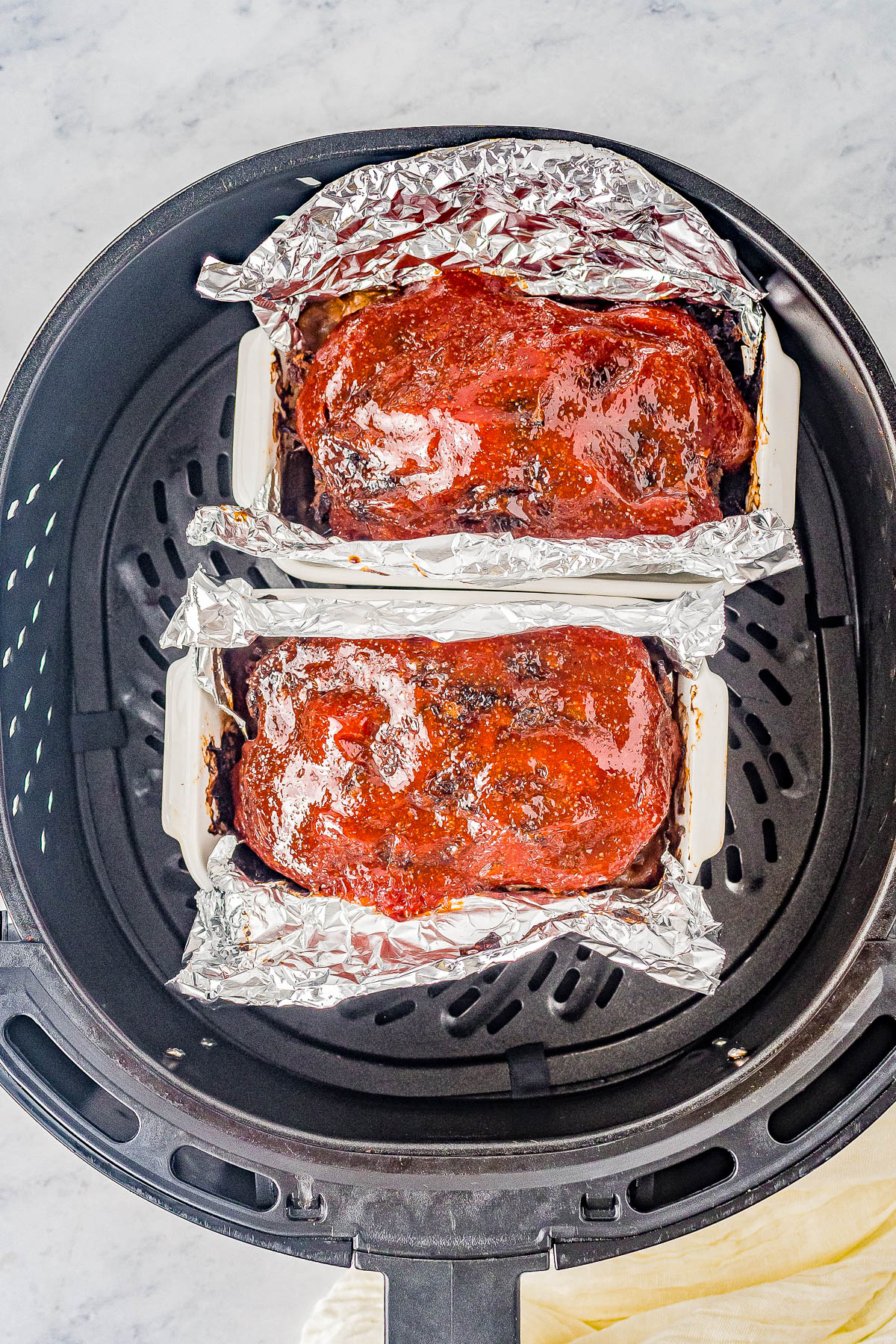 Air Fryer Meatloaf - Learn how to make AMAZING meatloaf in your air fryer! It cooks in half the time that it does in the oven, has perfectly crisped edges, and the interior stays juicy and moist! I use ground turkey or ground chicken to keep it HEALTHIER but ground pork, ground sausage, or ground beef can be used! Oven baking instructions also provided.