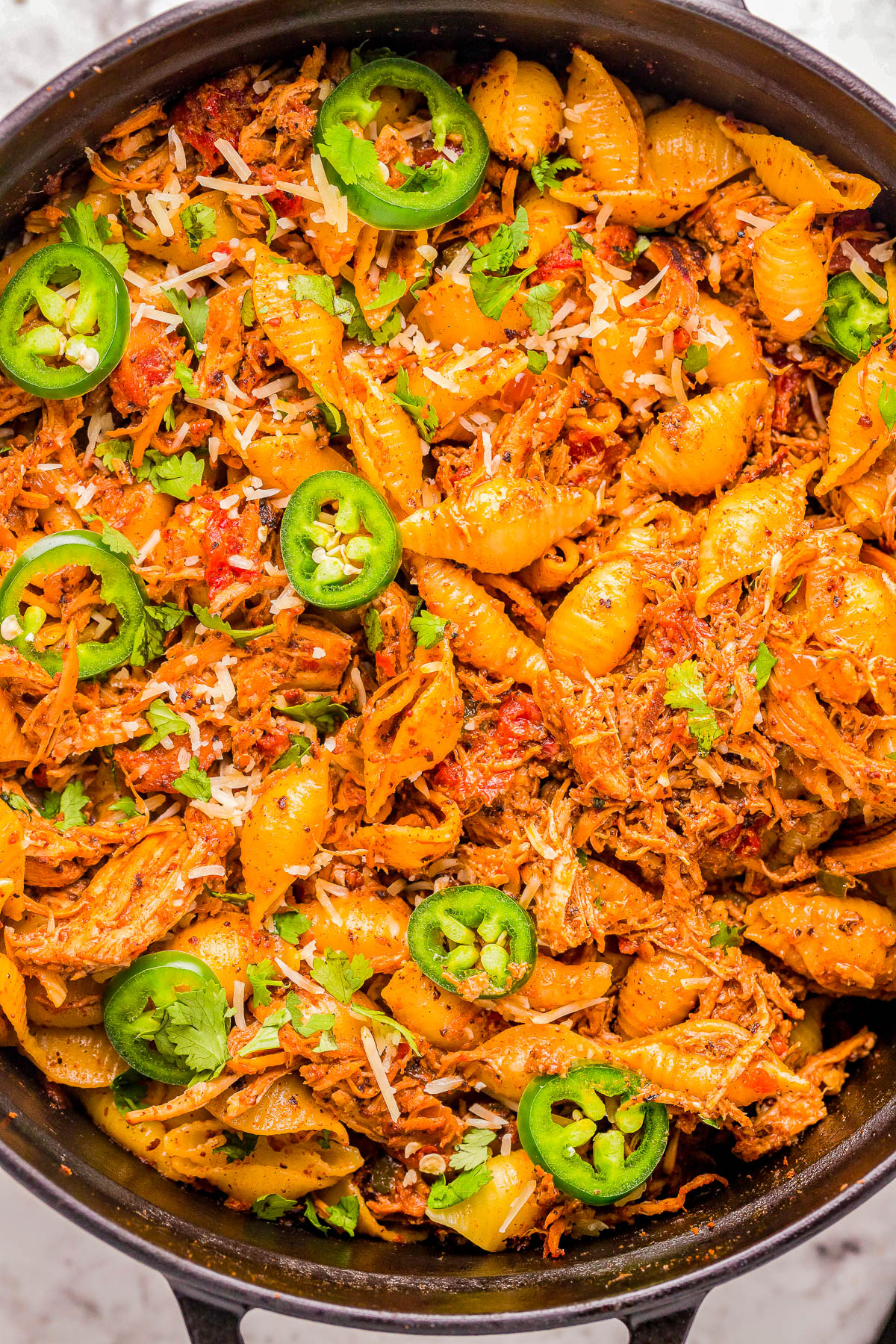 Chicken Chorizo Pasta - Tender pasta shells are mixed with chorizo and seasoned shredded chicken in a cream cheese and tomato based sauce for a truly FLAVORFUL comfort food dinner recipe! Ready in 45 minutes, EASY, and with just the right amount of heat to have everyone asking for seconds! 