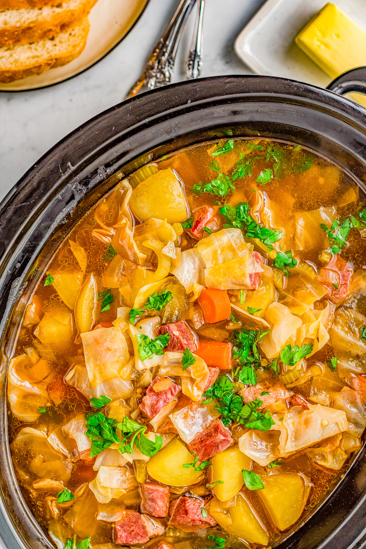 Slow Cooker Corned Beef and Cabbage Soup - Hearty comfort food complete with savory corned beef, potatoes, carrots, celery, and more! It's the EASIEST soup you'll ever make and will become a family FAVORITE especially when the weather is chilly! Stovetop cooking instructions also provided.