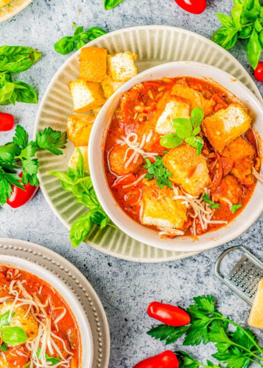 Easy 30-Minute Pizza Soup Recipe - Enjoy a big bowl of comfort food with hearty soup that mimics your favorite pizza! Complete with pepperoni, meatballs, a tomato-based broth, and topped with mozzarella, Parmesan, and garlic toast croutons for the "crust"! Easy enough for busy weeknights and sure to be a family FAVORITE!