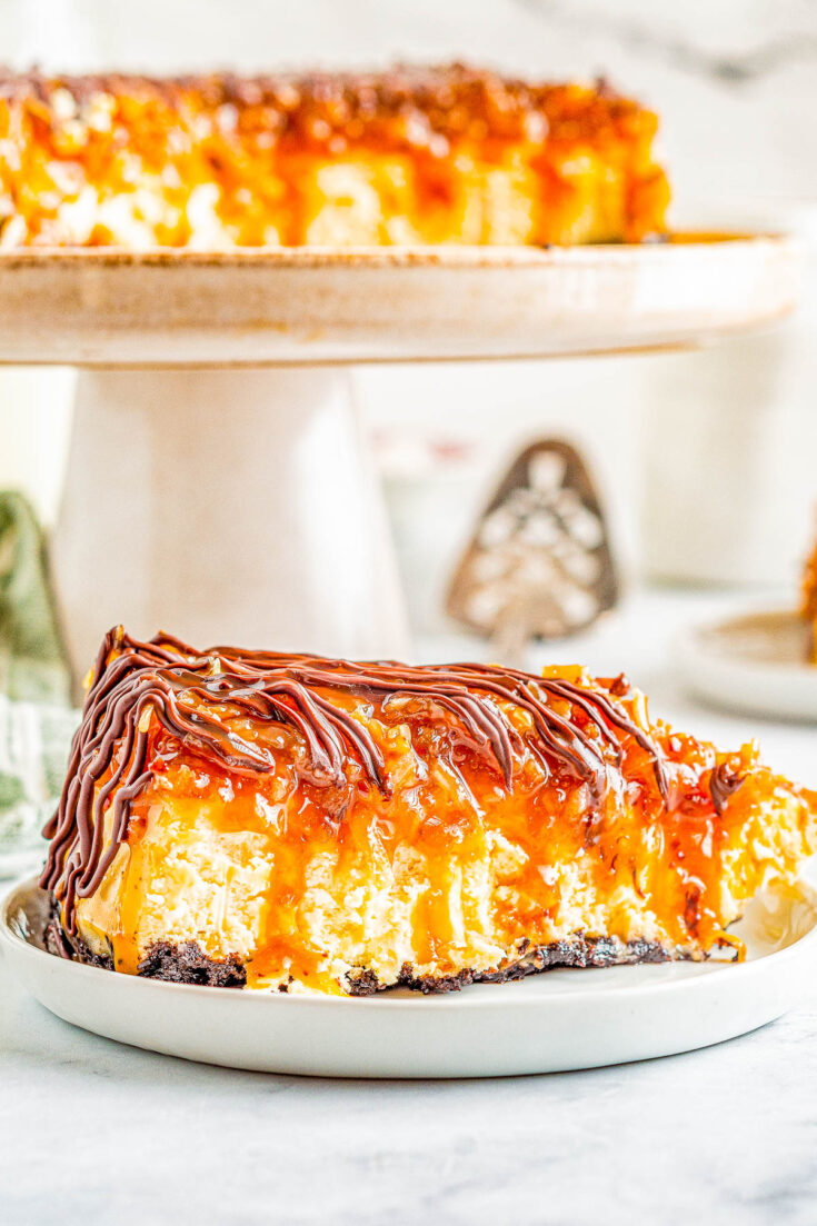 Samoa Cheesecake - Smooth, creamy cheesecake with an Oreo crust and topped with chewy toasted coconut, caramel, and chocolate! If you're a fan of Girl Scout Samoas Cookies, this homemade rich and decadent cheesecake with the same flavors is PURE PERFECTION! Clear and easy directions even if you've never made a cheesecake so yours turns out amazing.