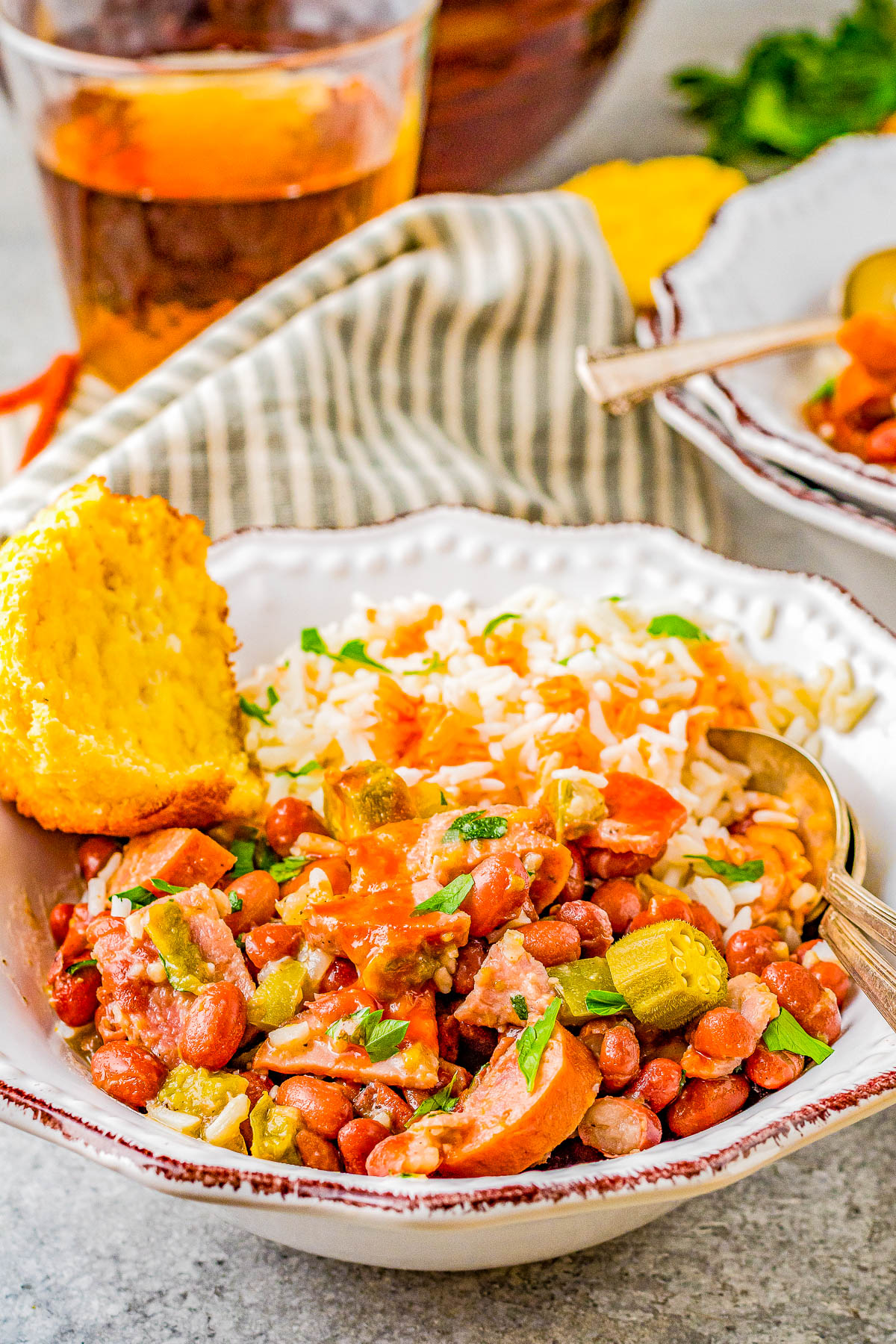Red Beans and Rice - Louisiana style red beans and rice is a Southern comfort food classic that's EASY to make! Complete with Andouille sausage, ham, Creole seasoning, tender red beans, and plenty of fluffy rice, this dish packs some spiciness but it'll leave you coming back for more! 