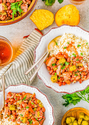 Red Beans and Rice - Louisiana style red beans and rice is a Southern comfort food classic that's EASY to make! Complete with Andouille sausage, ham, Creole seasoning, tender red beans, and plenty of fluffy rice, this dish packs some spiciness but it'll leave you coming back for more!