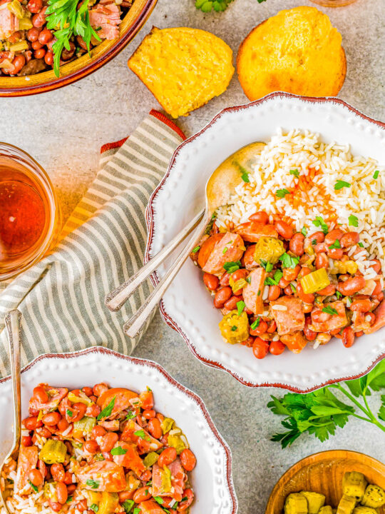 Red Beans and Rice - Louisiana style red beans and rice is a Southern comfort food classic that's EASY to make! Complete with Andouille sausage, ham, Creole seasoning, tender red beans, and plenty of fluffy rice, this dish packs some spiciness but it'll leave you coming back for more!