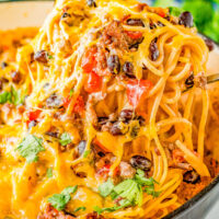 Taco Spaghetti - Tender spaghetti noodles are tossed in a creamy cheese sauce along with seasoned ground beef, tomatoes, green chiles, black beans, and cilantro! The PERFECT family-friendly weeknight dinner recipe that's super EASY and ready in 30 minutes!
