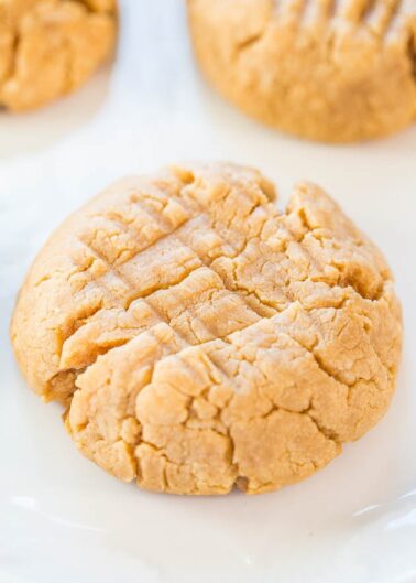 Homemade peanut butter cookie displayed on a white plate.