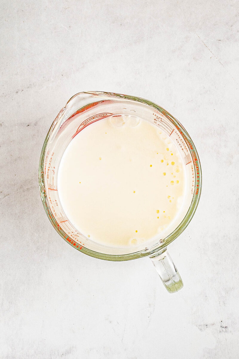 Milk and lemon juice being combined in a bowl.