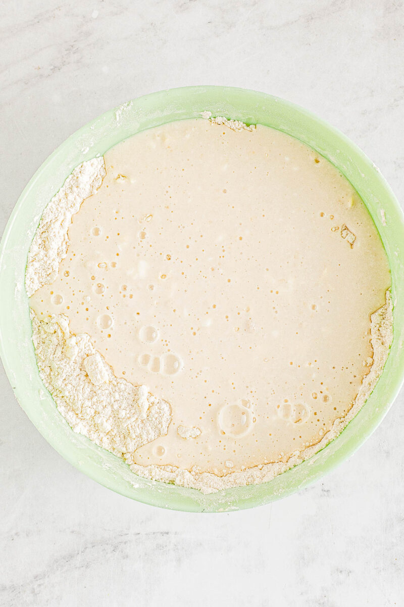 Angel biscuit dough being combined in a bowl.