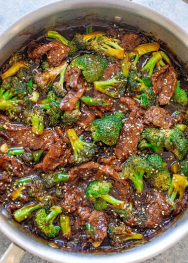 Stir-fried beef and broccoli in a savory sauce, served in a cooking pot.