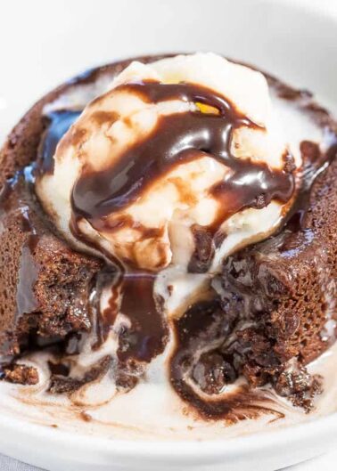 Molten lava cake with a scoop of vanilla ice cream and chocolate sauce.