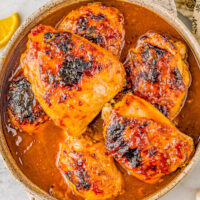 A bowl of honey soy baked chicken thighs.