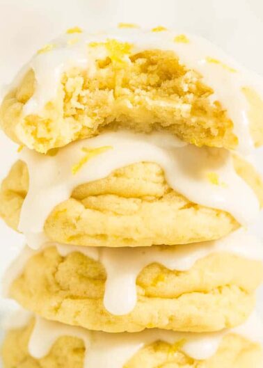 A stack of frosted lemon cookies with a zesty topping.