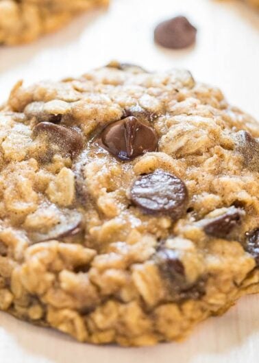 Close-up of a chocolate chip oatmeal cookie on a light surface.