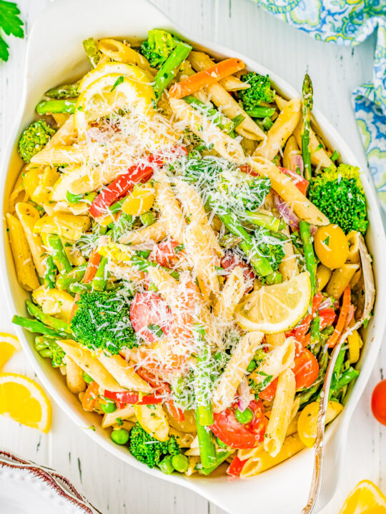 Pasta Primavera - An EASY pasta recipe that's chock full of brightly colored and lightly sautéed vegetables, penne pasta, and tossed in a light lemon cream sauce with Parmesan cheese! Great for busy weeknights when you need to get a family-approved dinner on the table quickly and you can sneak in lots of veggies!