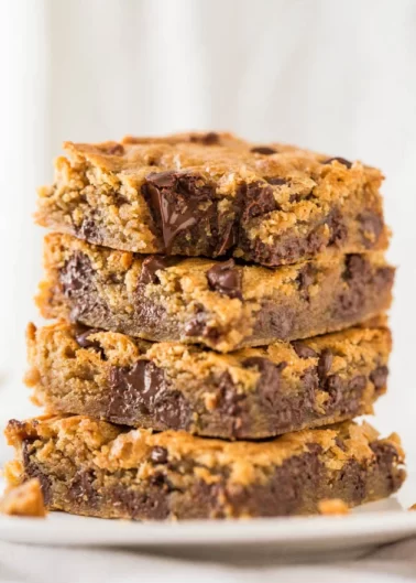 Stack of chocolate chip blondies on a plate.