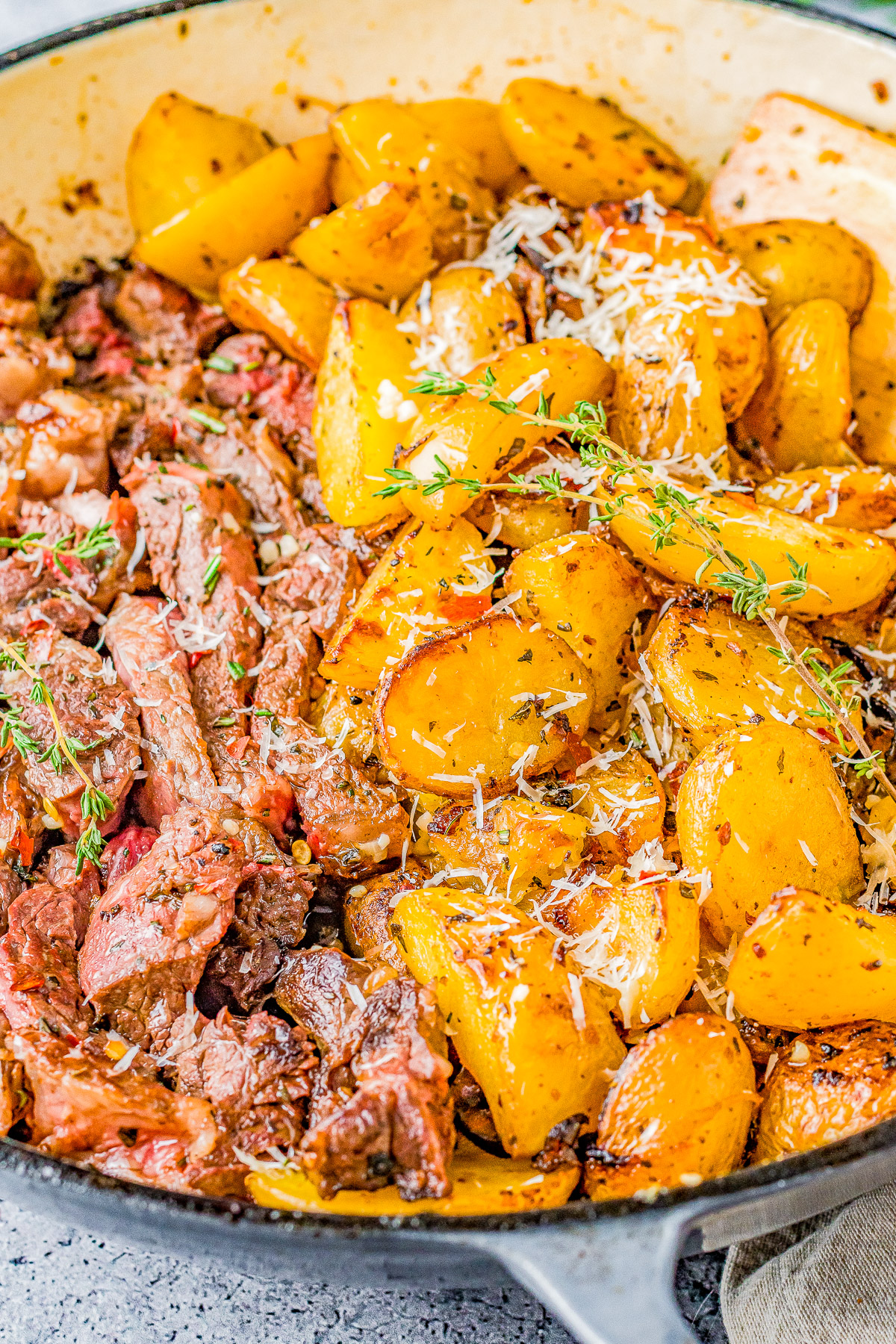 Steak and Potatoes Skillet - Made with garlic butter, herbs and spices, these juicy steak bites just melt in your mouth! Plus there are buttery and tender potatoes with lightly crisped edges. Made in just ONE skillet and ready quickly, my EASY recipe walks you through how to make the PERFECT steak and potatoes meal!
