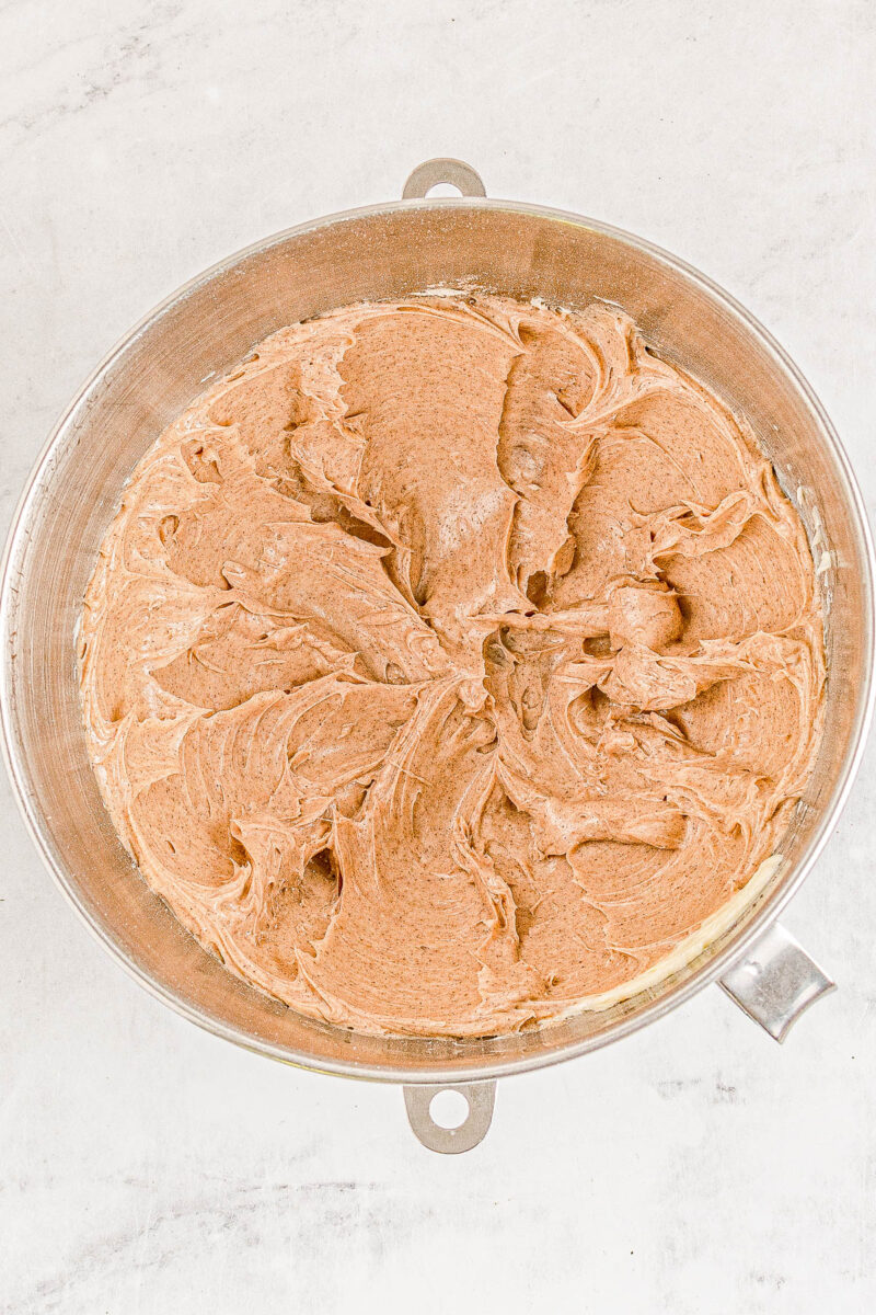 Whipped honey cinnamon butter in a stand mixer bowl.