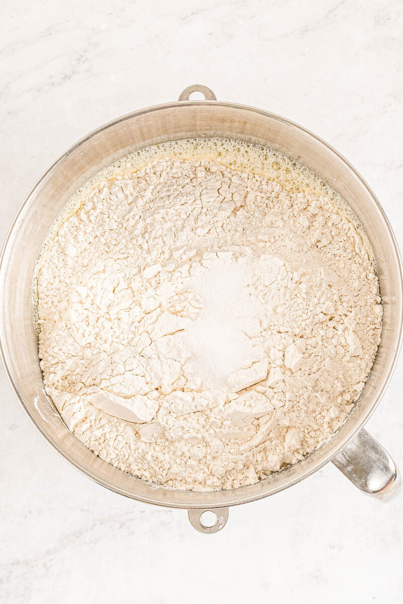 Wet and dry ingredients for copycat Texas Roadhouse rolls being combined in a bowl.