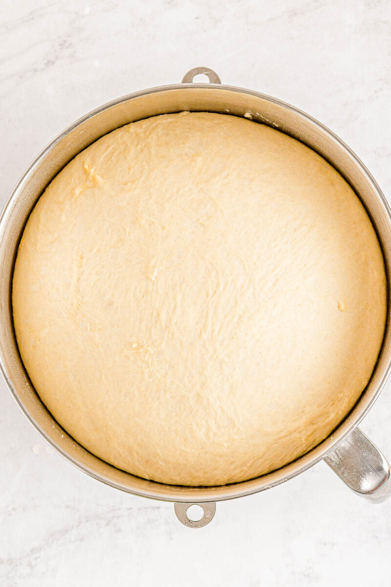 Proofed dough for homemade Texas Roadhouse rolls in a bowl.