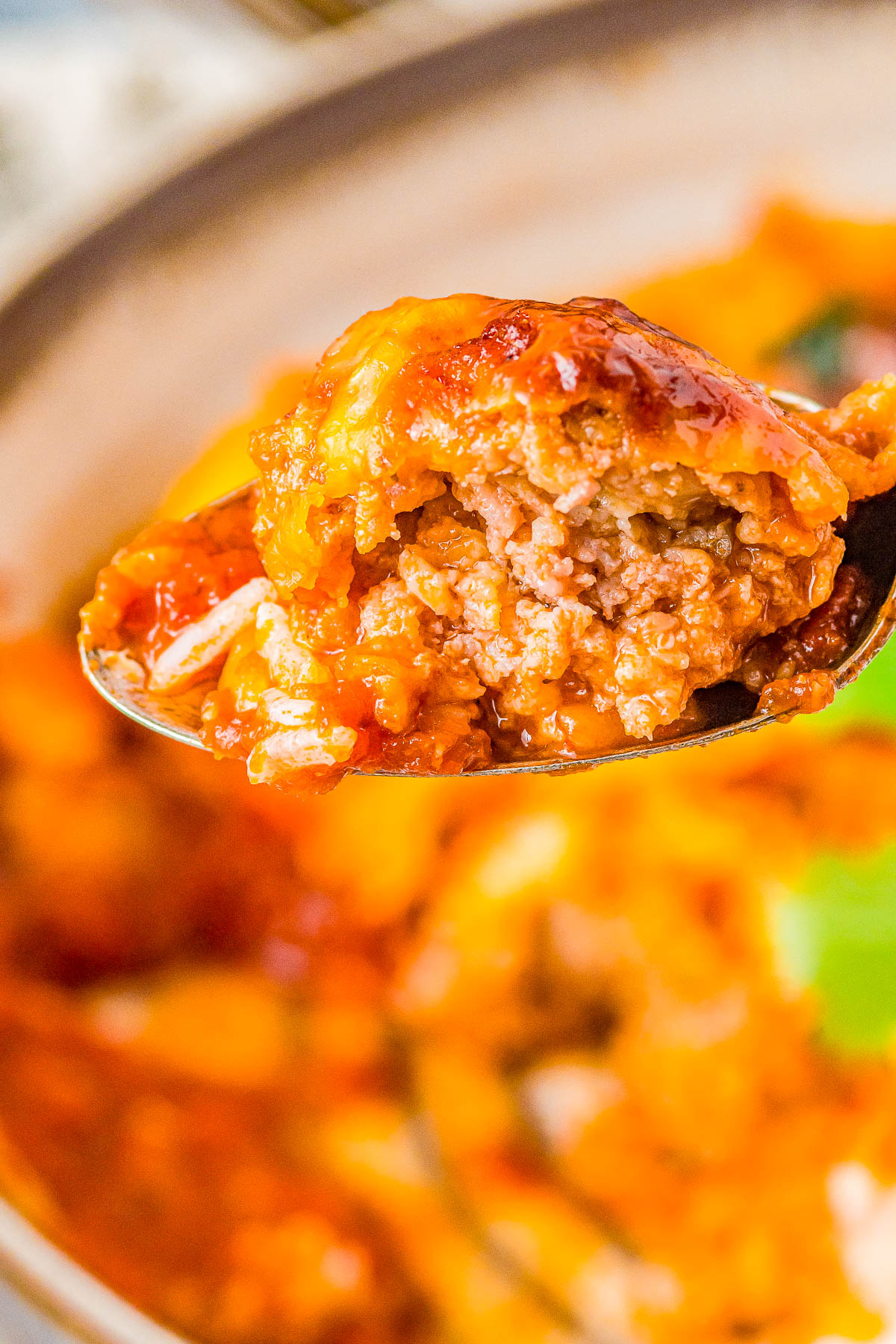 Tex Mex Meatballs - Tender, juicy homemade beef and pork meatballs with just the right amount of spicy kick! Simmered in chipotle enchilada sauce and smothered with melted cheese, this EASY meatball recipe will become a weeknight family dinner favorite. Or make them as a game day or party appetizer recipe!