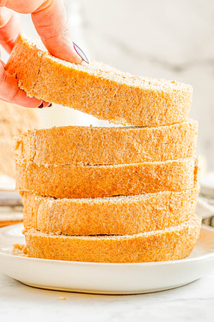 Honey Whole Wheat Bread - An EASY and foolproof homemade bread recipe for honey sweetened whole wheat bread! It's soft, thick, and scrumptious! Serve it plain, toast it, make sandwiches with it, or serve it with honey butter which is my favorite! Even if you're never made bread before, my recipe is straightforward and do-able.